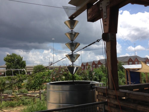I love this rainwater catcher at the north Birmingham, Ala., Jones Valley Teaching Farm. The roof of the structure is ridged inward, rather than upward. Called at "butterfly roof," it channels rainwater into this cistern. The funnels keep the water from splashing out. (Photo by Jim Ewing)